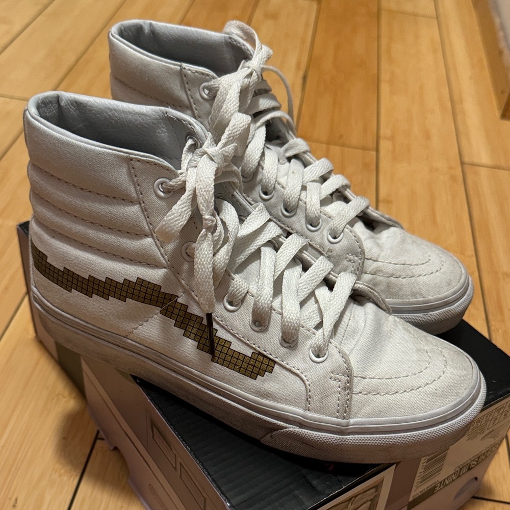 Vans White High-Top Sneakers with Gold Pixel Stripe
